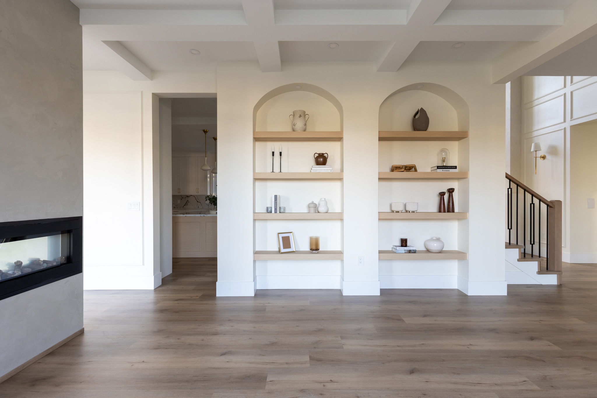 Signature Service project — living room with arched built-in shelving and double-sided fireplace